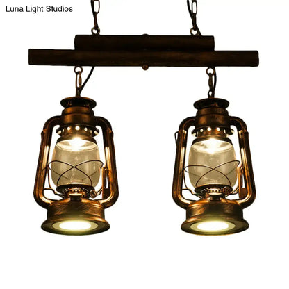 Vintage-style brass decorbites™ copper lantern island light with clear glass bulbs hanging from dark wooden beam