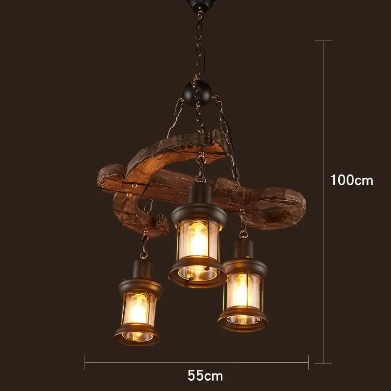 Rustic vintage wood ceiling chandelier with three brass lanterns hanging from a curved weathered wood frame