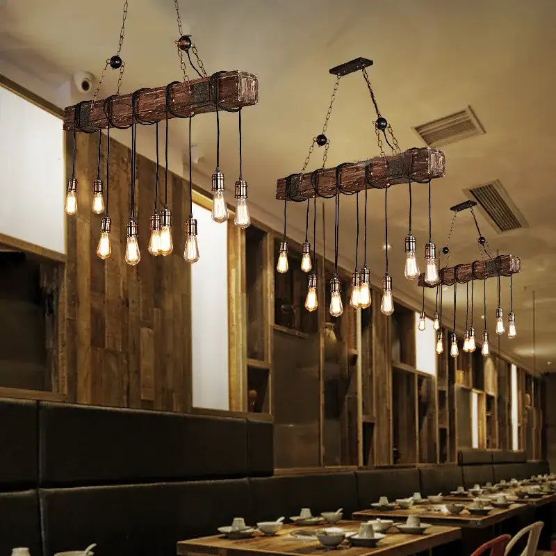 Rustic wood ceiling chandelier with vintage wood beams and multiple exposed filament bulbs hanging in dining room