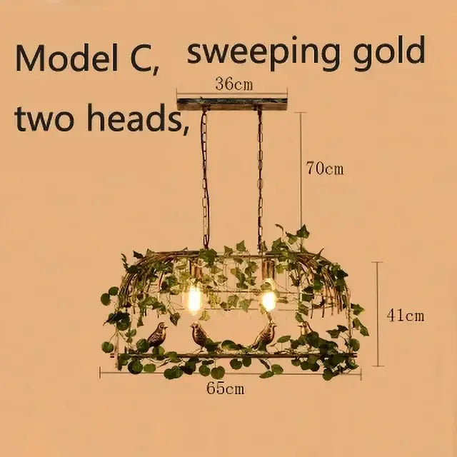 Vintage wrought iron bird cage chandelier in sweeping gold with two heads featuring intricate vine and bird detailing