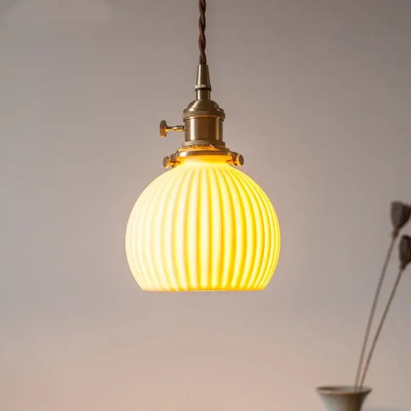 Warm yellow ribbed glass led pendant light with brass-finished metal fixture for kitchen dining room pendant lights