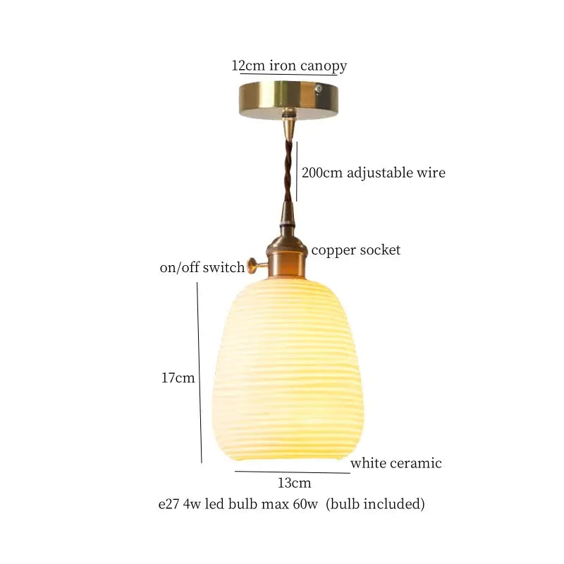 A warm white ceramic led pendant light with ribbed texture and brass hardware for kitchen dining room use