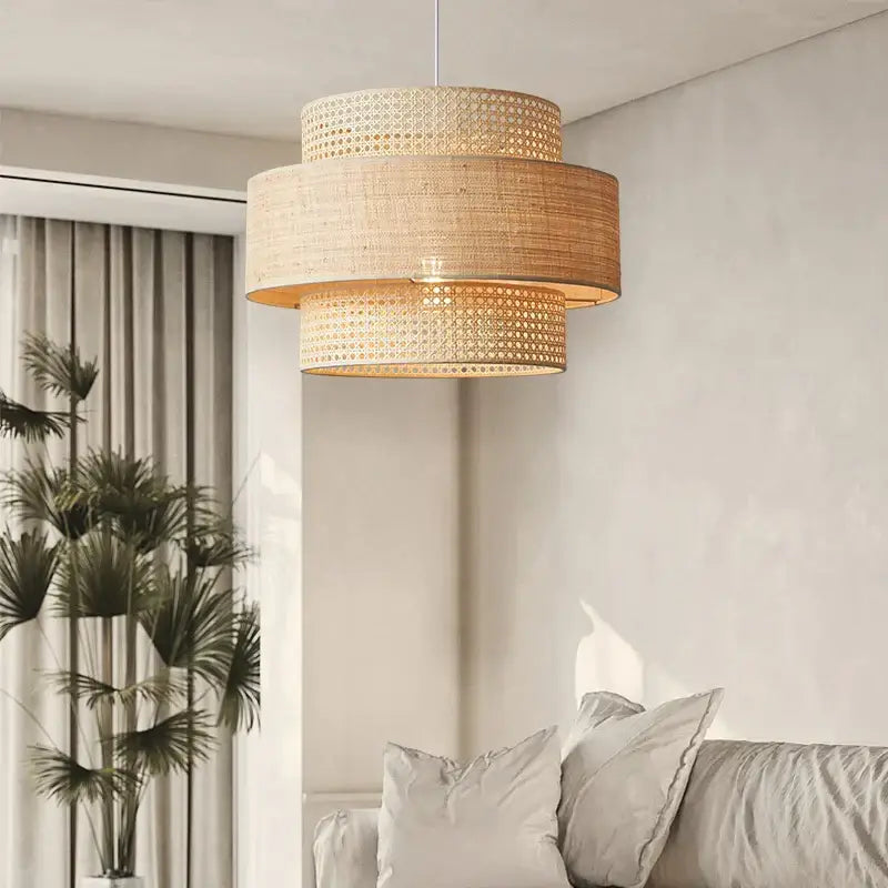 Beige woven rattan wabi sabi pendant light with three tiered cylindrical sections for dining room layered shade