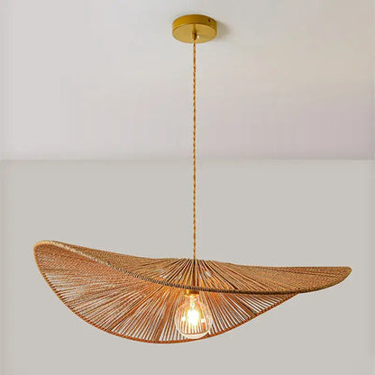 A warm-toned woven rattan bamboo wabi sabi pendant light with golden fixture for dining room illumination