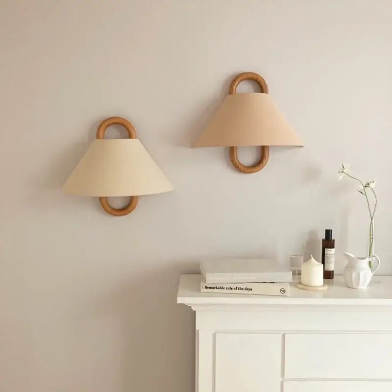 Beige conical fabric shade wall lamp mounted on natural beech wood ring beech wood wall lamp for bedroom