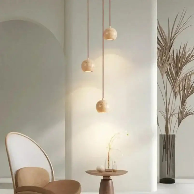 Three beige and brown wooden pendant lights with matte finish and dark cords for decorbites elegant wabi dining rooms