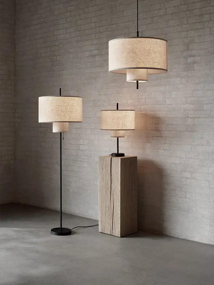 Beige linen cylindrical pendant lamps and floor lamps with black metal frames perfect for bohemia wabi sabi decorbites bohemia wabi