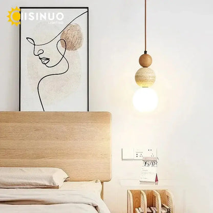 Wabi sabi beige stone and wooden accent pendant light with two stacked wooden orbs and glowing bulb on thin cord pendant