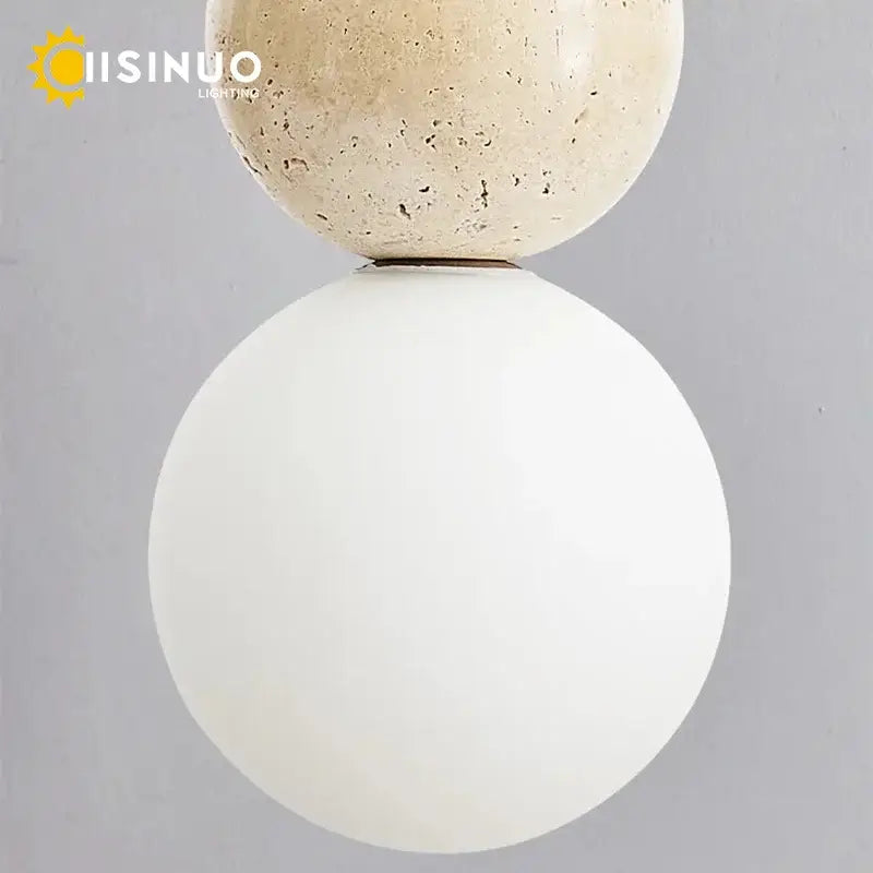 Modern wabi sabi pendant light with beige stone top sphere, smooth white glass globe, and wooden accent for dining room