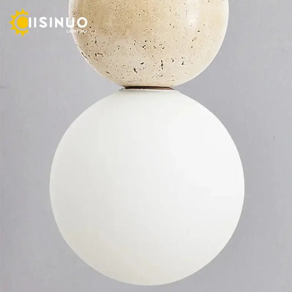Modern wabi sabi pendant light with beige stone top sphere, smooth white glass globe, and wooden accent for dining room