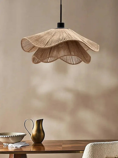 Wabi-sabi brown and beige woven rattan pendant light with black metal fixture offers stylish cord pendant installation