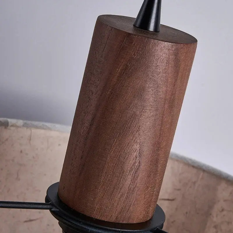 A cylindrical wooden lamp base with rich brown grain and black finial in decorbites cream wabi-sabi chandelier lamp