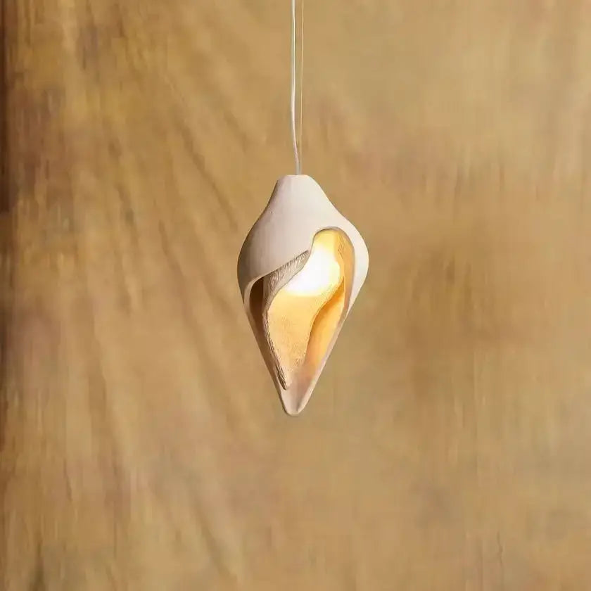 Wabi sabi cream gypsum conch pendant lamp with off-white ceramic shell design and warm golden glow for living room decorbites gypsum conch pendant