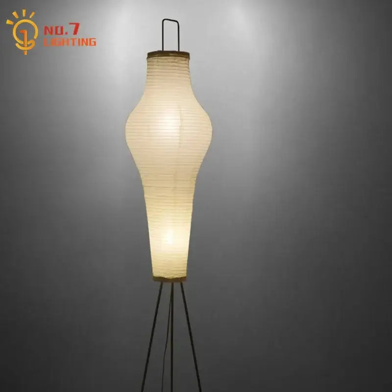Wabi-sabi cream paper tripod floor lamp with slender elongated body and warm soft glow for living room decor