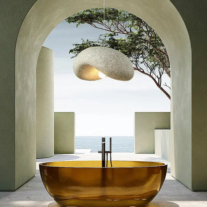 A sleek amber-gold freestanding bathtub paired with wabi sabi cream style led chandelier for elegant decorbites cream style decor