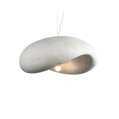 A modern off-white cream style led pendant light with textured organic shape and warm glow for dining room decorbites