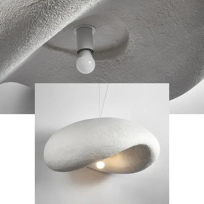 A modern textured white pendant light with a smooth organic oval shape and soft interior glow for dining room decorbites cream style cream style led