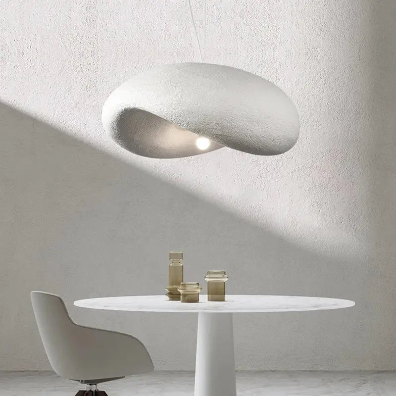 A sleek off-white pendant light with a textured cloud shape in decorbites cream style led for dining room decor