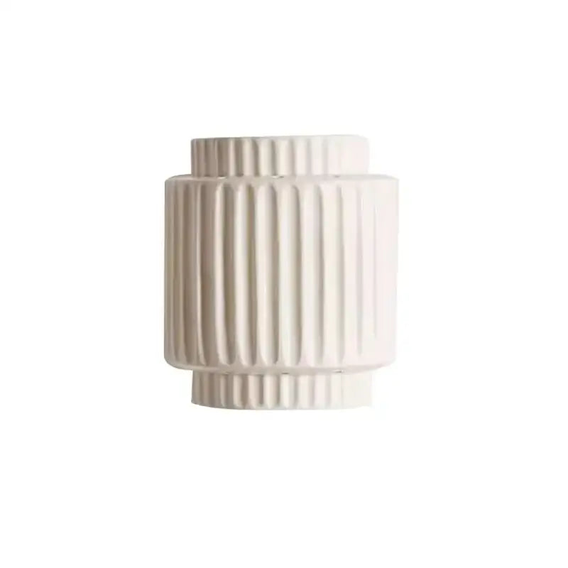 Cream white resin wabi-sabi wall lamp with a cream-colored ceramic vase featuring vertical fluted ridges and tiered shape
