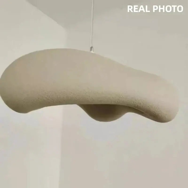 Beige textured organic shaped creamy white cloud led pendant light suspended by thin cord for bedroom hanging lamp