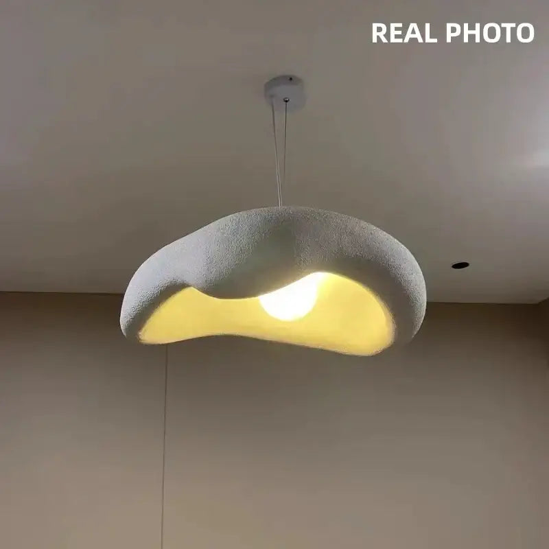 Wabi sabi creamy white cloud led pendant light with textured gray fabric exterior and warm yellow glow for bedroom