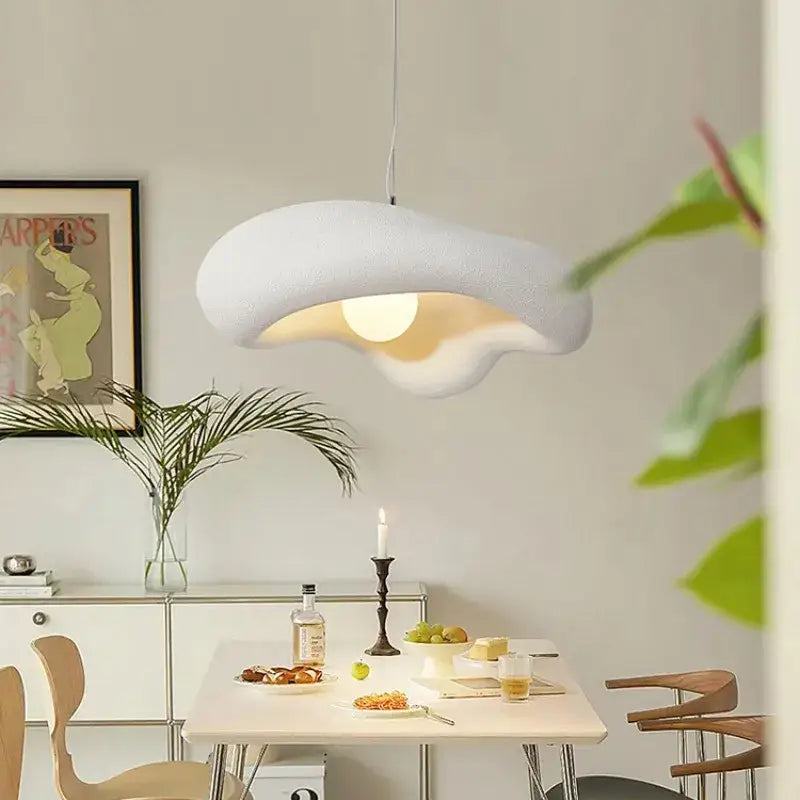 Wabi sabi creamy white cloud led pendant light with textured surface hanging above the dining table