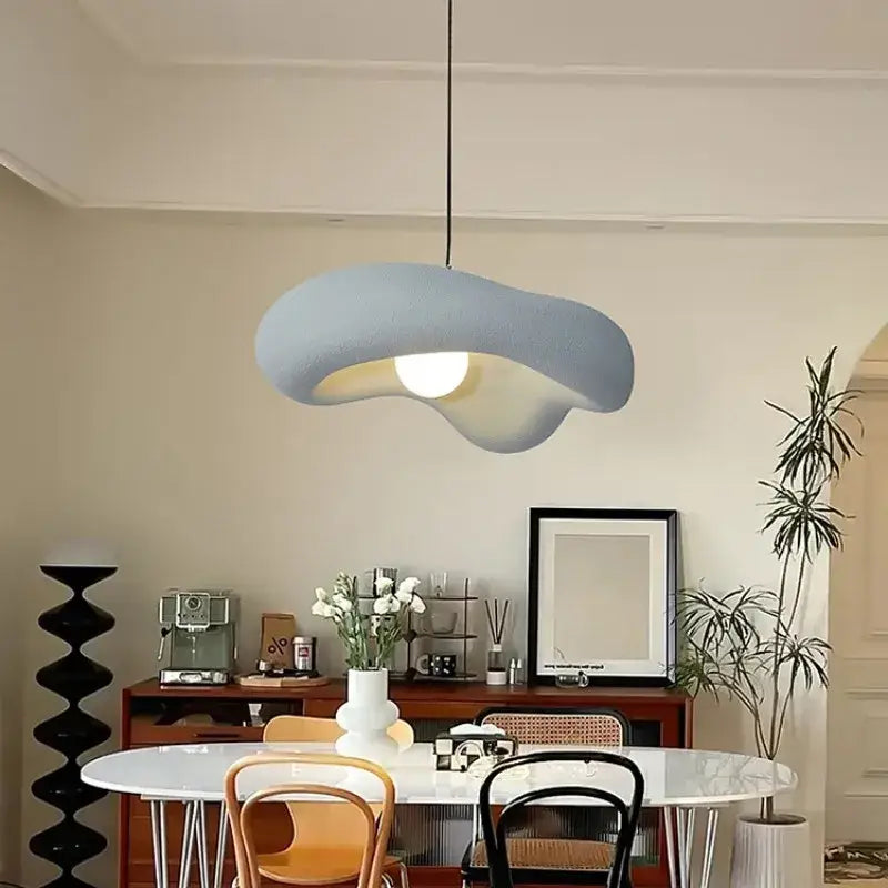 Wabi sabi creamy white cloud led pendant light with textured muted blue surface hanging in bedroom ceiling