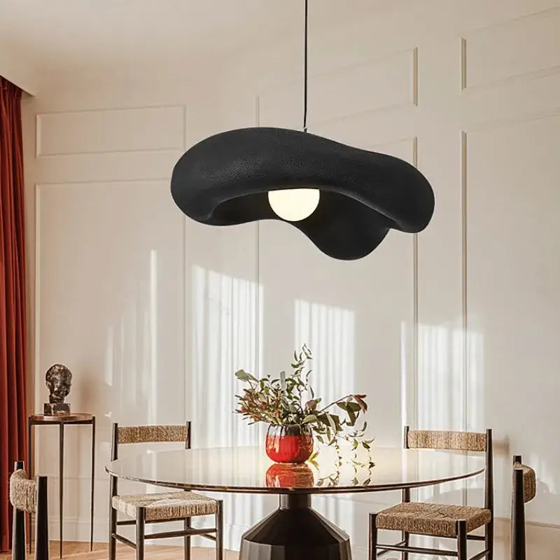 Black textured led pendant light with organic cloud shape and central circular bulb for bedroom lighting