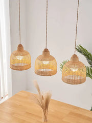 Three hanging decorbites bamboo pendant lamps with warm golden glow and natural woven texture for dining room island