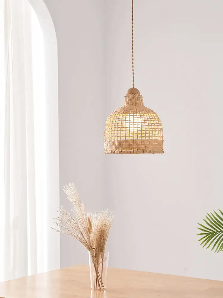 A warm-toned woven rattan decorbites bamboo pendant lamp with natural wood top for dining room island lighting