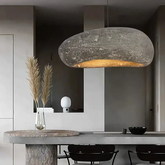 Wabi sabi gray decorbites handmade polystyrene indoor pendant light with textured stone finish and warm golden glow
