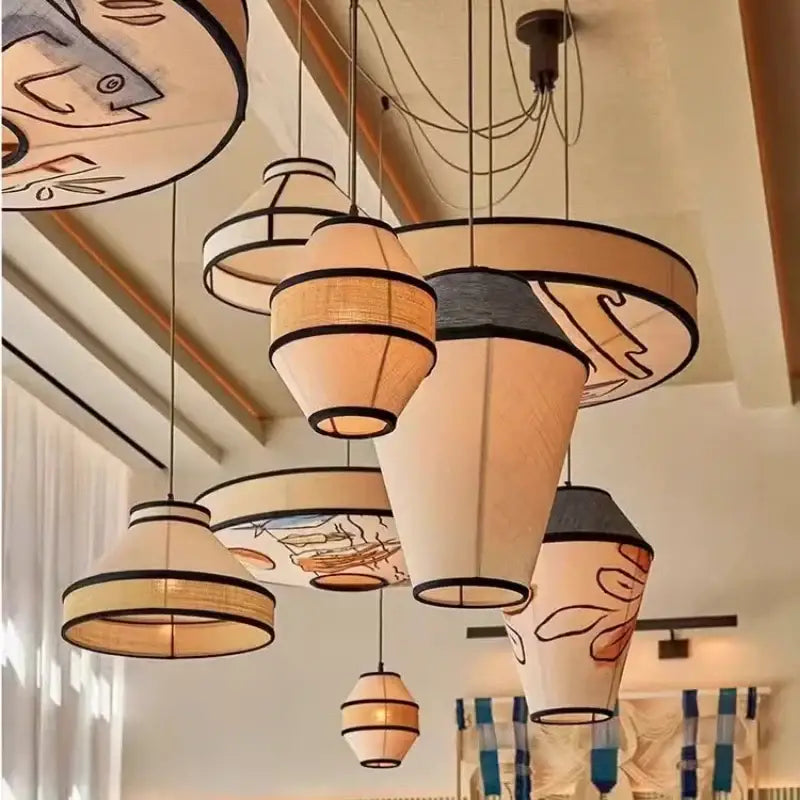 Beige and black woven fabric pendant lamp with whimsical fish illustrations for dining room wabi sabi decorbites colored wabi