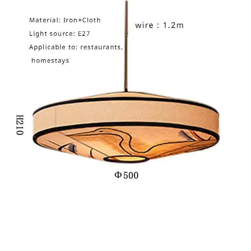 Wabi sabi pendant lamp with beige cloth shade featuring abstract orange black patterns hanging by iron wire for dining room