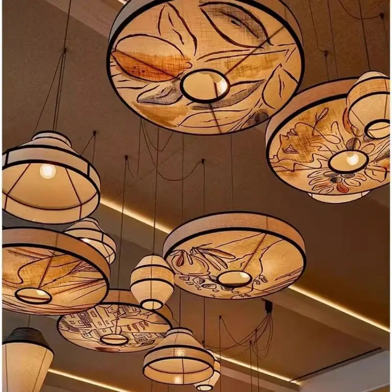 Handcrafted wabi sabi pendant lamp with hand-painted botanical illustrations in warm earth tones and woven natural fiber decorbites colored wabi