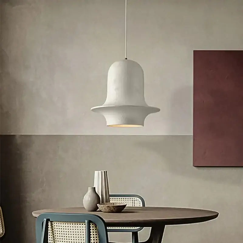 A sleek white ceramic bell-shaped pendant light from decorbites black wabi-sabi industrial chandelier collection