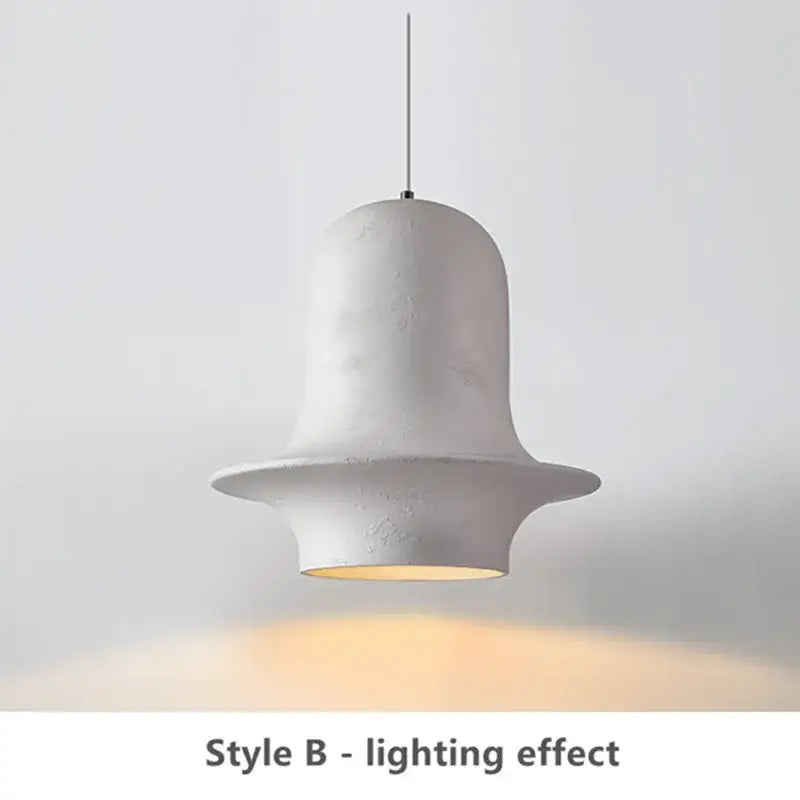 White ceramic bell-shaped pendant light with matte finish and warm glow for decorbites black wabi-sabi industrial chandelier
