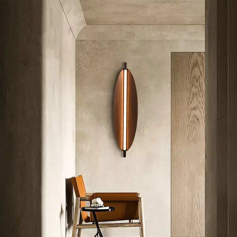 A sleek copper led wabi sabi wall sconce with a vertical light strip for a warm amber glow in dining room lighting