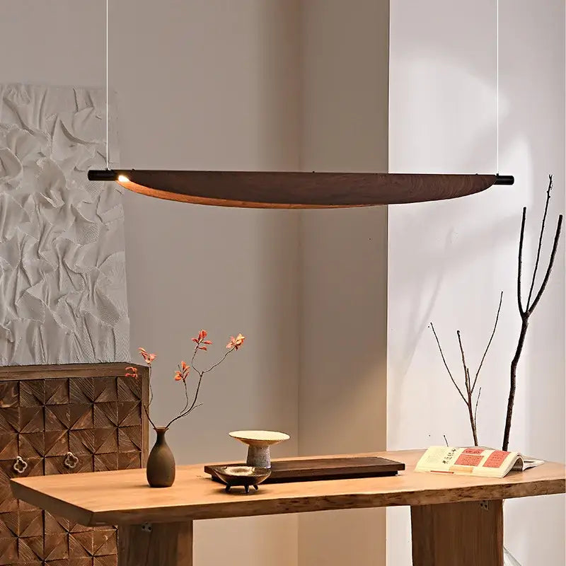 A sleek dark wood led wabi sabi pendant light with minimalist design and warm amber glow for dining room