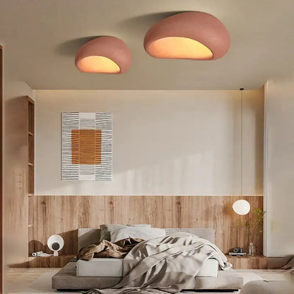 Two blush pink dome-shaped matte ceiling chandelier lights with warm glow for bedroom cream ceiling decor
