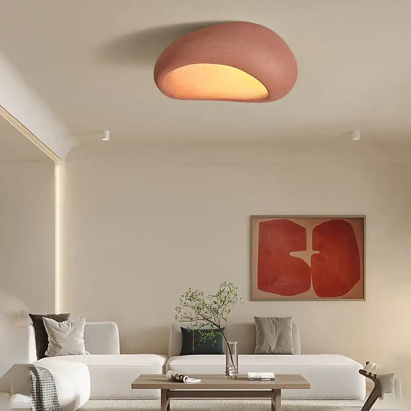 A warm terracotta cream ceiling chandelier with a smooth organic shape and softly diffused glow for bedroom lighting