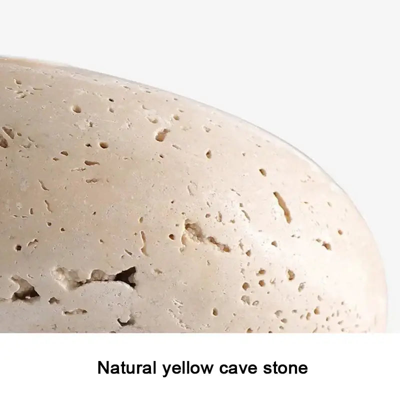 Wabi-sabi off-white stone pendant light with smooth rounded yellow cave stone and textured surface for dining room