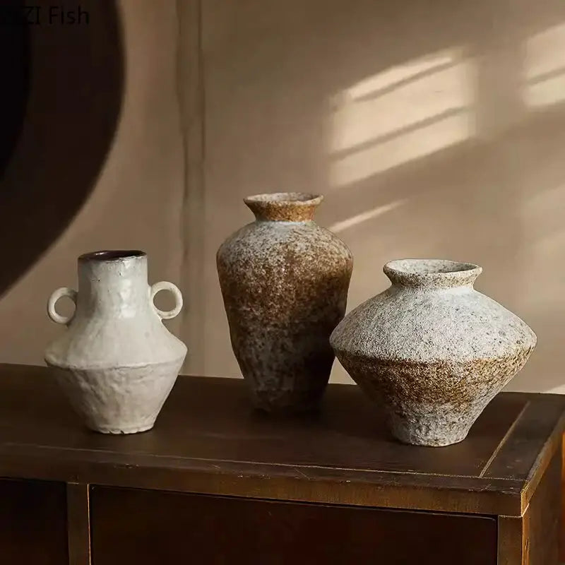 Three rustic decorbites ceramic vases with speckled white and brown glaze and unique shapes including dual handles