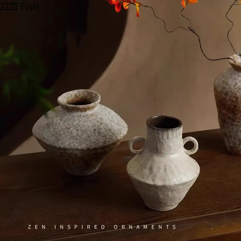 A white decorbites ceramic vase with two small handles and a textured matte finish for living room decor