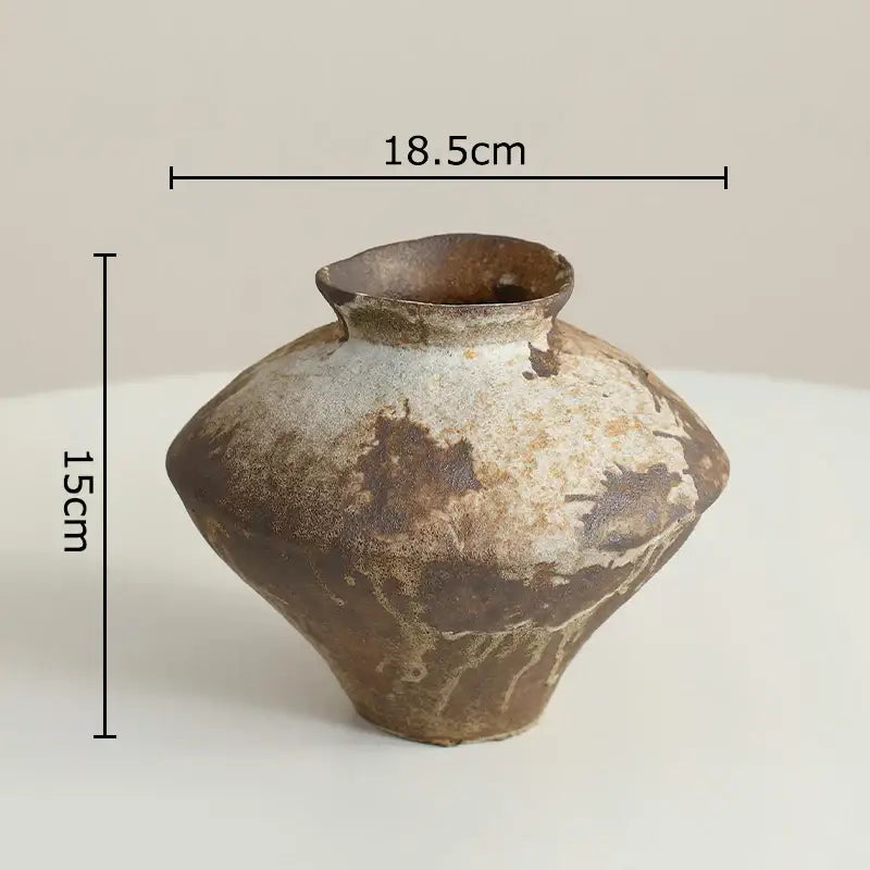 A wabi-sabi rustic brown decorbites ceramic vase with mottled glaze and uneven rim for living room decor