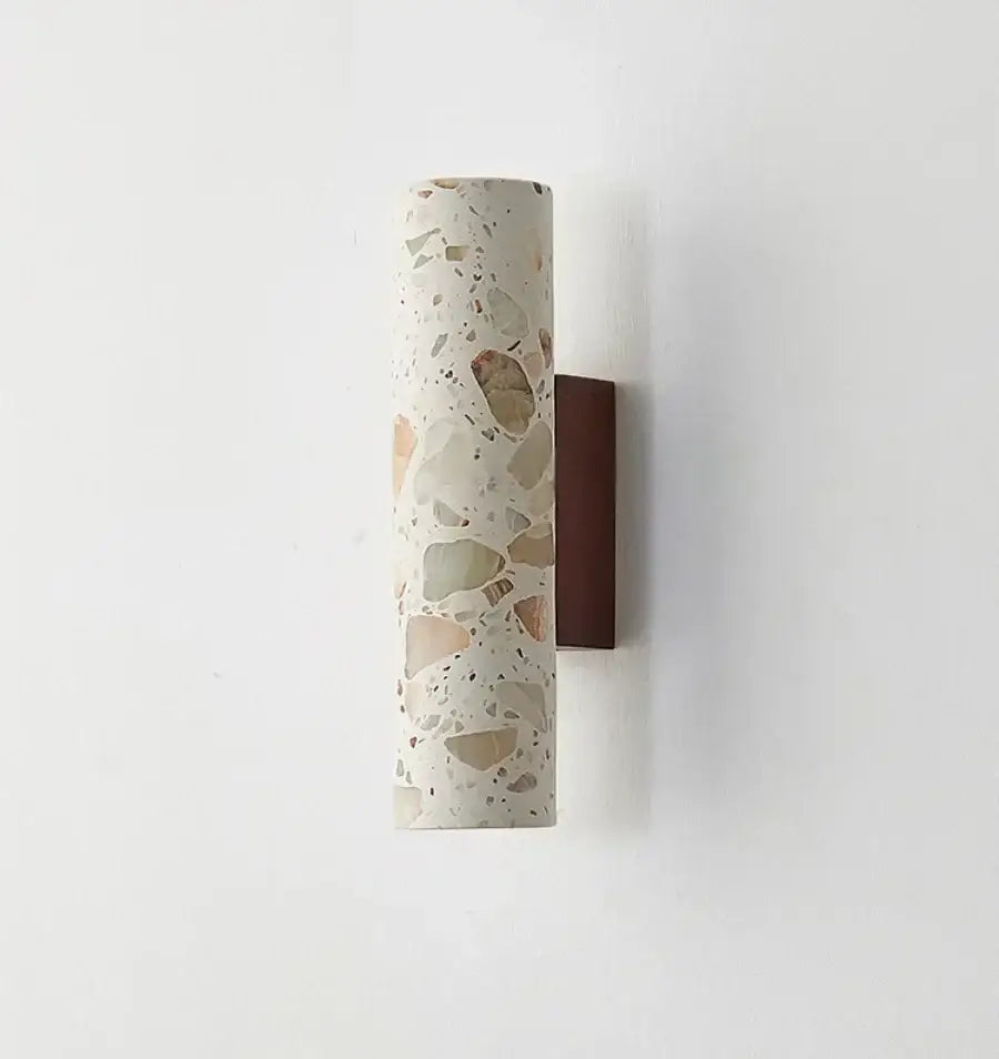 Wabi sabi terrazzo and wood led wall lights with cylindrical speckled white beige and brown stone sconce on dark wood backplate