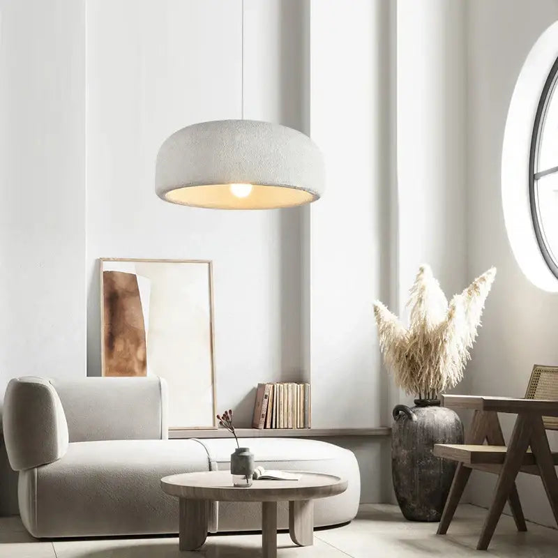 Wabi sabi textured off-white ceramic led pendant light with warm circular glow for dining room illumination