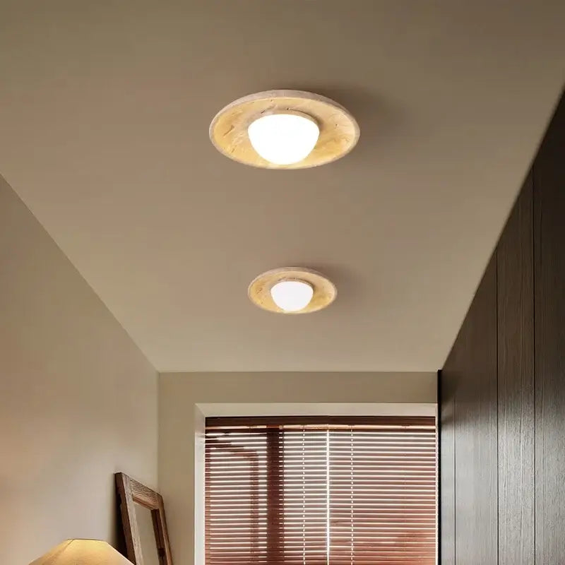 Two circular recessed ceiling lamps with warm white bulbs and rustic wood canopy in wabi sabi bedroom decorbites acrylic led design
