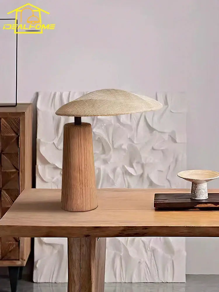 A rustic vintage wooden desk lamp with a woven natural fiber shade and cylindrical wooden base for desk lighting