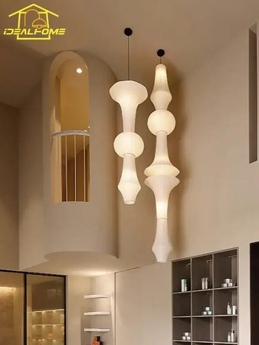 Two elegant wabi sabi white paper pendant lights with a beautifully understated sculptural design for bedroom decor