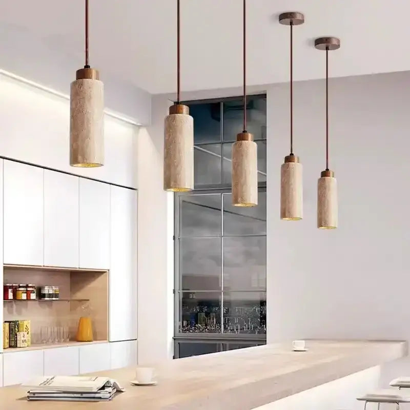 Four cylindrical pendant lights with yellow marble textured bodies and brass tops for modern interiors and bedrooms